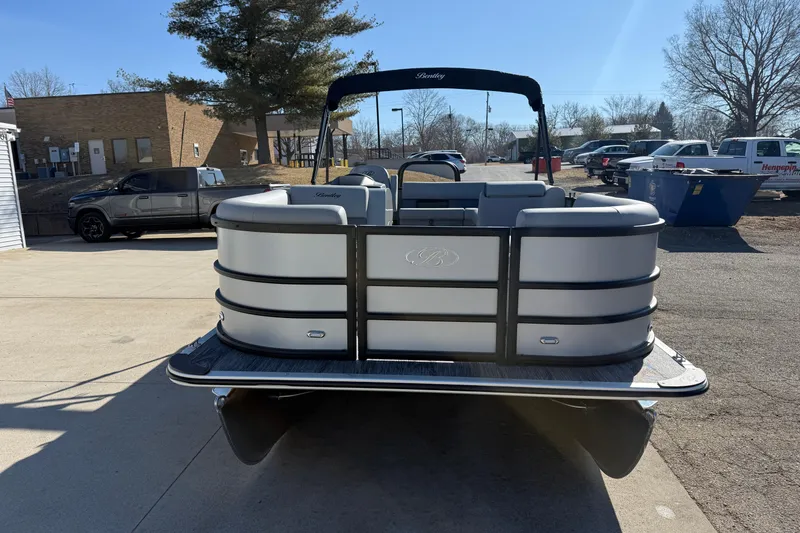 Slide: The Image of 2026 Bentley Pontoons Legacy 200 Cruise XL pontoon boat in a parking lot. - 2