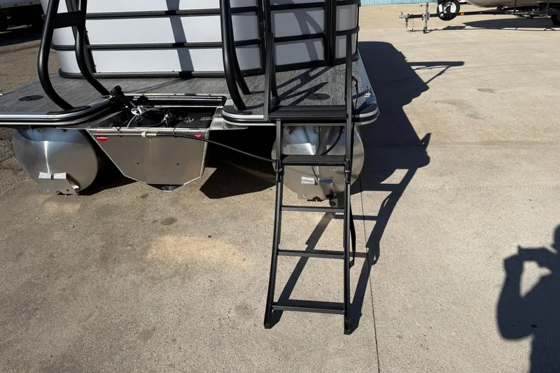 Slide: The Image of 2026 Bentley Pontoons Legacy 200 Cruise XL with rear ladder and pontoons on concrete surface. - 8