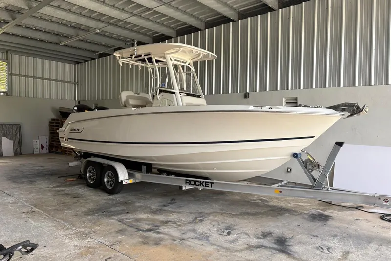 The Image of 2021 Boston Whaler 230 Outrage boat on trailer in a metal storage facility. - 1