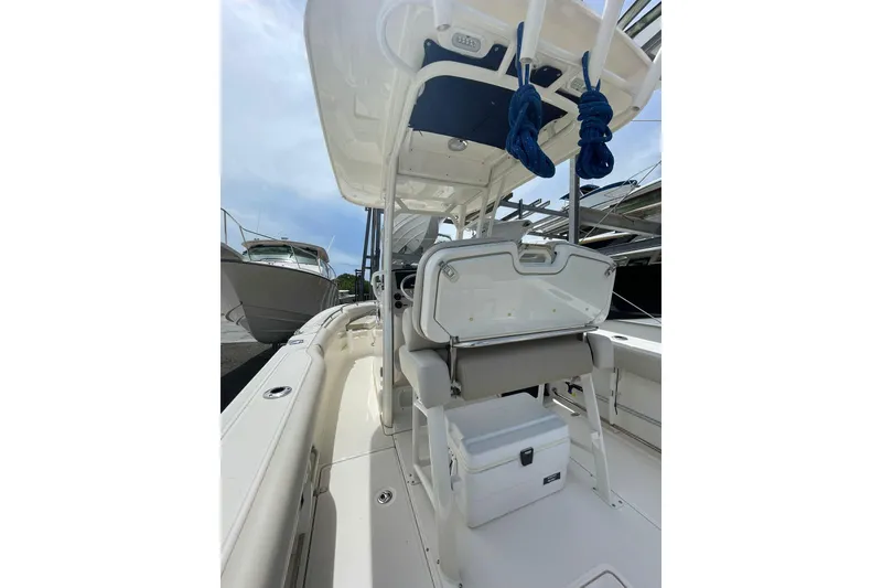 Slide: The Image of 2021 Boston Whaler 230 Outrage boat interior with seating and storage. - 11