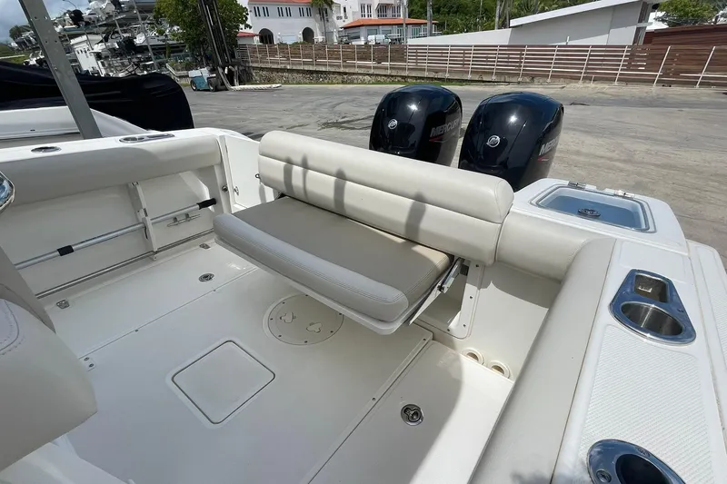 Slide: The Image of 2021 Boston Whaler 230 Outrage boat interior with seating and dual Mercury engines. - 12