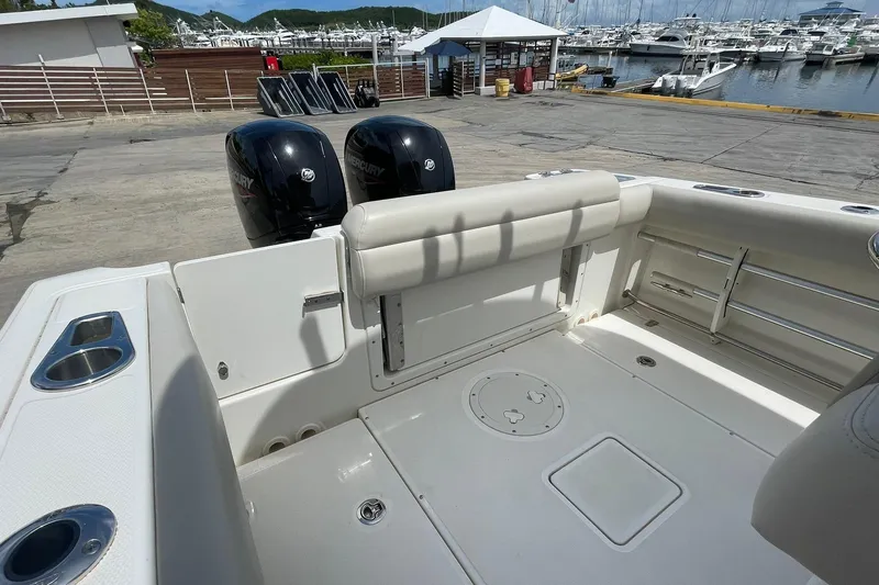 Slide: The Image of 2021 Boston Whaler 230 Outrage boat interior with dual Mercury engines at marina. - 13