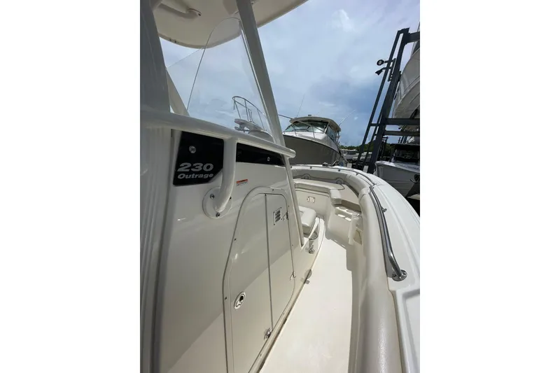 Slide: The Image of 2021 Boston Whaler 230 Outrage boat interior with seating and storage compartments. - 7