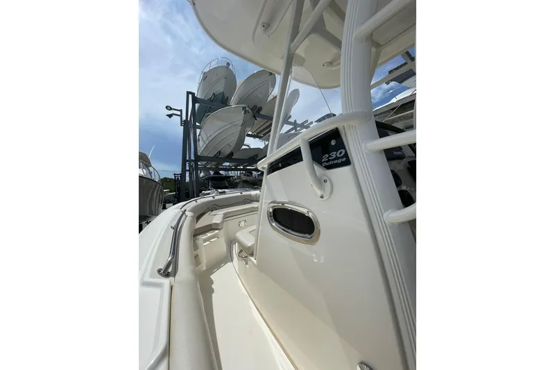 Slide: The Image of 2021 Boston Whaler 230 Outrage boat interior with stacked boats in background. - 8