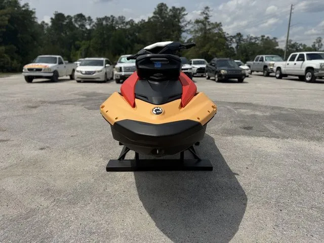 Slide: The Image of 2026 Sea-Doo Spark for 2, red and yellow, in parking lot. - 3