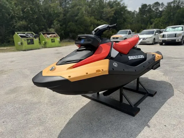 Slide: The Image of 2026 Sea-Doo Spark for 2, red and yellow, displayed in parking lot. - 4
