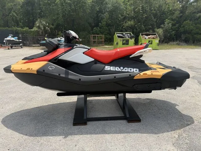 Slide: The Image of 2026 Sea-Doo Spark for 2, black and red, on a stand outdoors. - 5