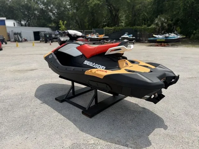 Slide: The Image of 2026 Sea-Doo Spark for 2, yellow-black, on a stand outdoors. - 6