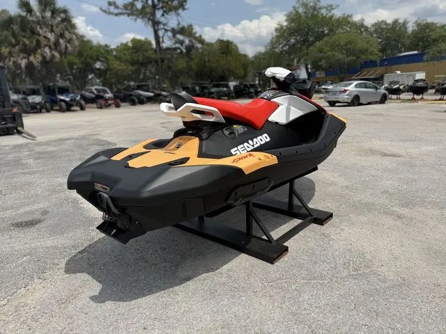 Slide: The Image of 2026 Sea-Doo Spark for 2, orange and black, on a parking lot. - 8