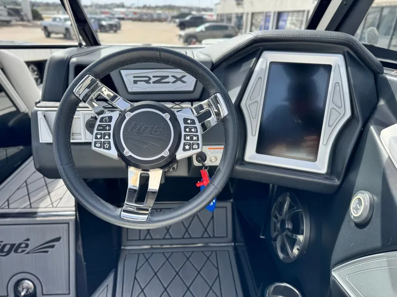 Slide: The Image of Interior of 2018 Tigé 23RZX with steering wheel and display. - 15