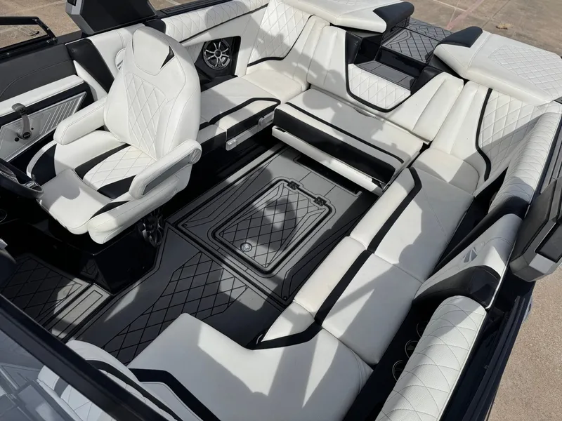 Slide: The Image of Interior of a 2018 Tigé 23RZX boat with luxurious white seating. - 18