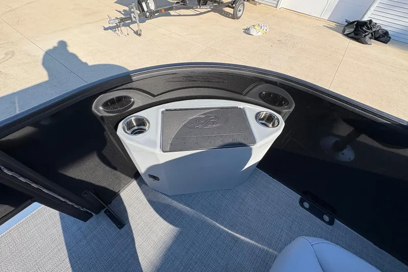 Slide: The Image of 2026 Bentley Pontoons Fish 220 FWD CW interior with cup holders and storage compartment. - 10
