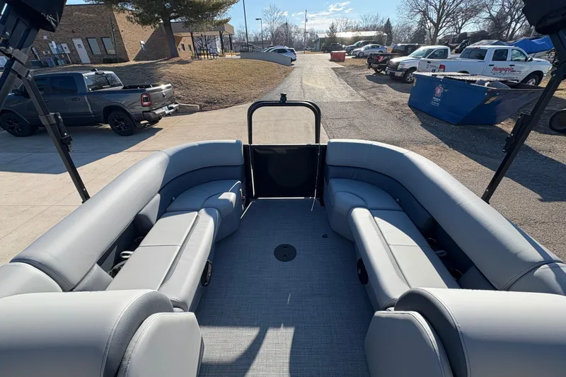 Slide: The Image of 2026 Bentley Pontoons Fish 220 FWD CW interior with gray seating, parked outdoors. - 16