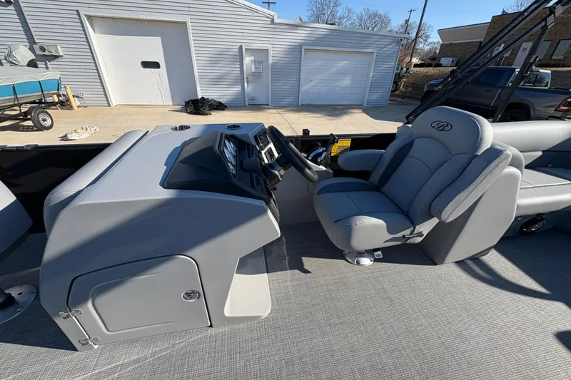 Slide: The Image of 2026 Bentley Pontoons Fish 220 FWD CW interior with captain's chair and control console. - 17