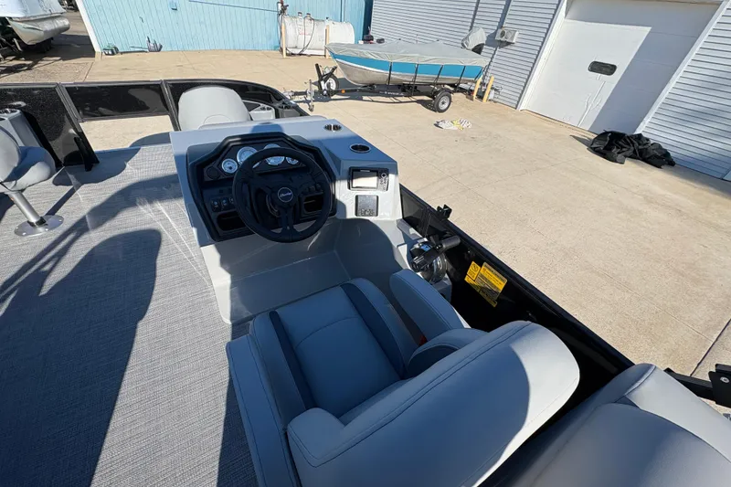 Slide: The Image of 2026 Bentley Pontoons Fish 220 FWD CW interior with steering console and seating. - 18