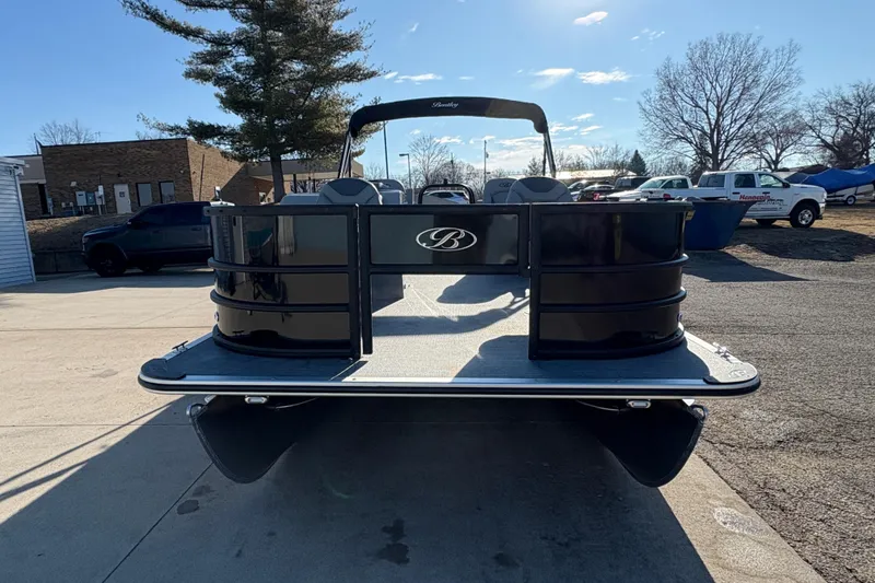 Slide: The Image of 2026 Bentley Pontoons Fish 220 FWD CW, sleek black design, parked outdoors. - 2