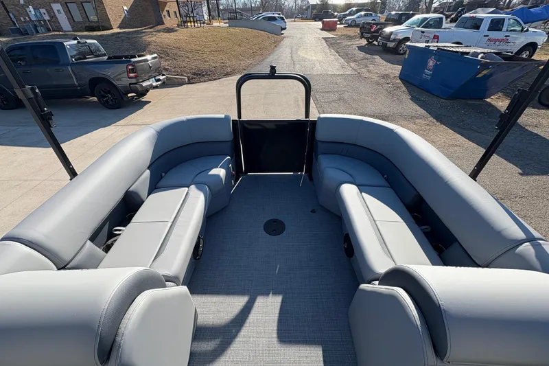 Slide: The Image of 2026 Bentley Pontoons Fish 220 FWD CW interior with gray seating, parked outdoors. - 26