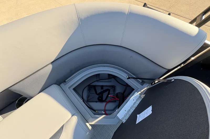 Slide: The Image of 2026 Bentley Pontoons Fish 220 FWD CW storage compartment with open seat and visible wiring. - 28