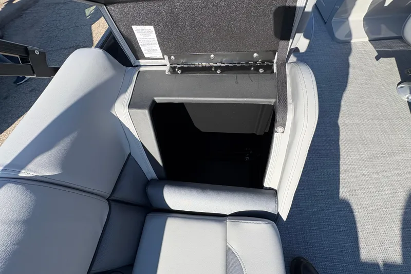 Slide: The Image of 2026 Bentley Pontoons Fish 220 FWD CW storage compartment with open seat lid. - 32