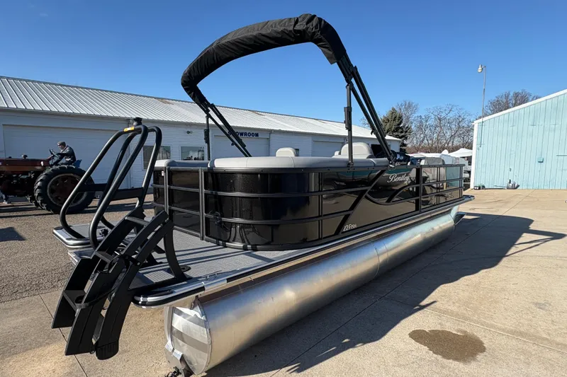 Slide: The Image of 2026 Bentley Pontoons Fish 220 FWD CW, black pontoon boat with canopy, docked outdoors. - 5