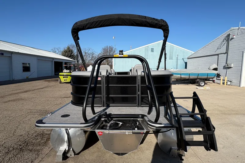 Slide: The Image of 2026 Bentley Pontoons Fish 220 FWD CW, rear view, docked under clear blue sky. - 6
