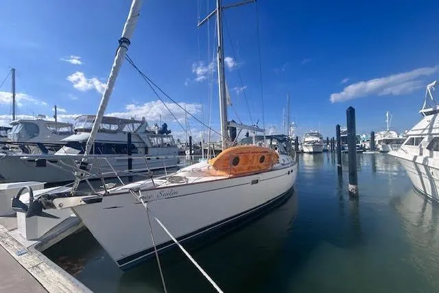 The Image of 2001 Beneteau Oceanis 461 sailboat docked at marina under clear blue sky. - 0