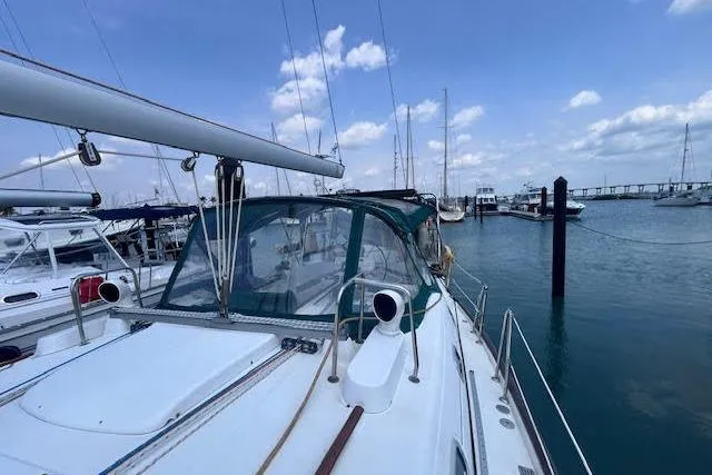 Slide: The Image of 2001 Beneteau Oceanis 461 sailboat docked in a marina under a clear blue sky. - 10