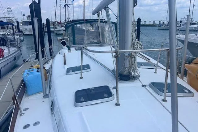 Slide: The Image of 2001 Beneteau Oceanis 461 sailboat docked at marina, showcasing deck and mast. - 12