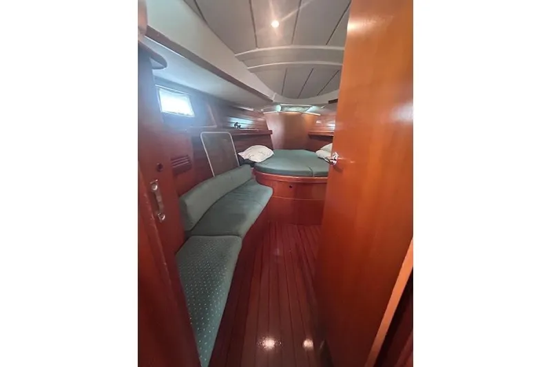 Slide: The Image of Interior cabin of 2001 Beneteau Oceanis 461 yacht with wooden finish and cozy seating. - 13