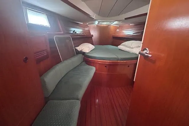Slide: The Image of Cozy cabin interior of 2001 Beneteau Oceanis 461 sailboat with wooden finish and seating. - 16