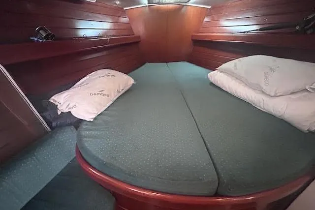 Slide: The Image of Cozy cabin interior of 2001 Beneteau Oceanis 461 sailboat with wooden paneling and bedding. - 17