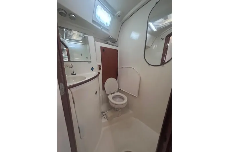 Slide: The Image of Bathroom interior of 2001 Beneteau Oceanis 461 yacht, featuring toilet and sink. - 18