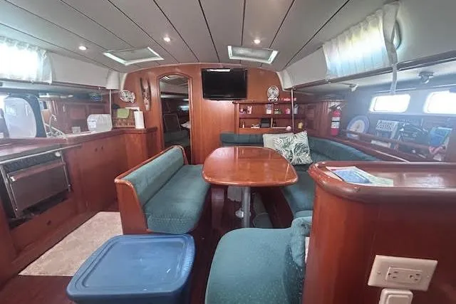 Slide: The Image of Interior of 2001 Beneteau Oceanis 461 yacht with wood finish and cozy seating area. - 24
