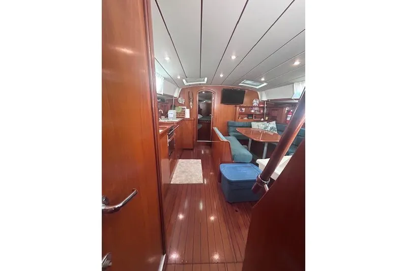 Slide: The Image of Interior of 2001 Beneteau Oceanis 461 yacht with wood finish and cozy seating area. - 27