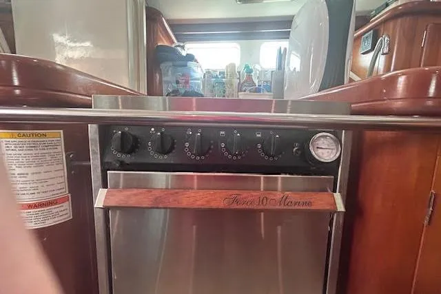 Slide: The Image of Interior of 2001 Beneteau Oceanis 461 yacht featuring a marine stove and oven. - 28