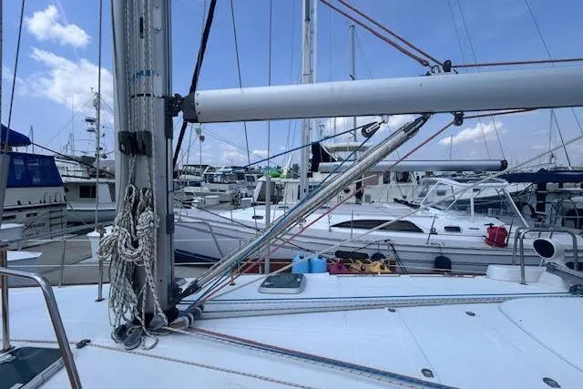 Slide: The Image of 2001 Beneteau Oceanis 461 sailboat docked at marina, surrounded by other boats. - 31