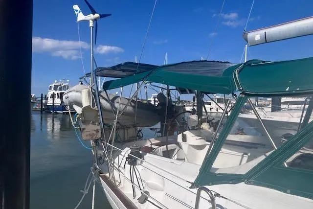 Slide: The Image of 2001 Beneteau Oceanis 461 sailboat docked in a marina under clear blue skies. - 4