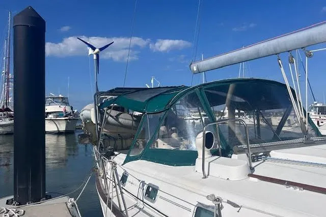 Slide: The Image of 2001 Beneteau Oceanis 461 sailboat docked at marina under clear blue sky. - 5