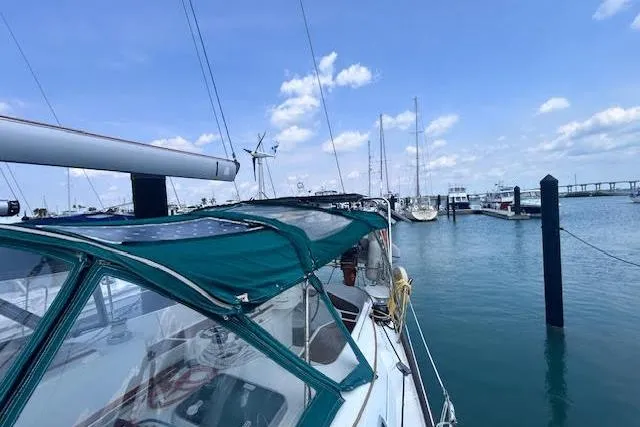 Slide: The Image of Sailboat Beneteau Oceanis 461, 2001 model, docked in a marina under a clear blue sky. - 9