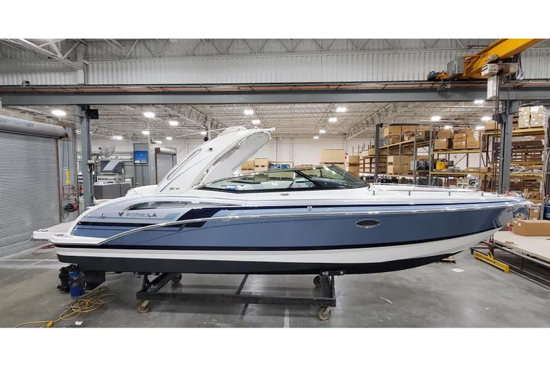 The Image of 2020 Formula 310 Bowrider boat in a warehouse setting, side view. - 0
