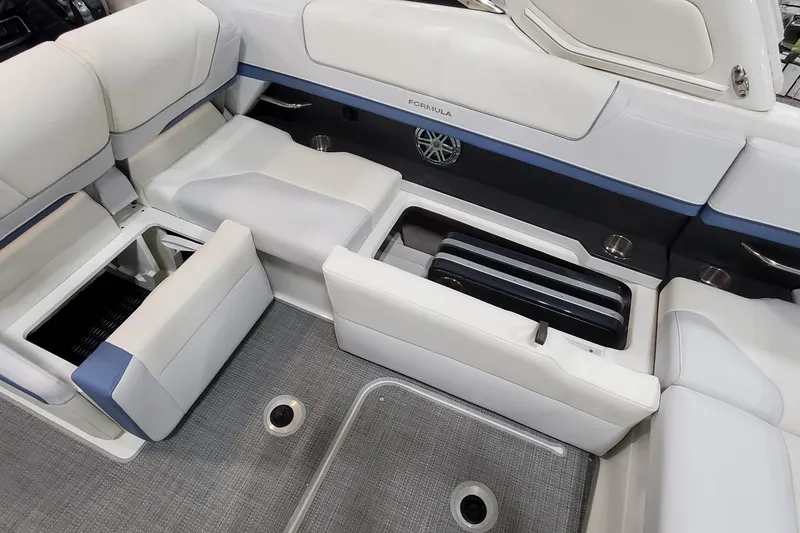 Slide: The Image of 2020 Formula 310 Bowrider interior with open storage compartments and cushioned seating. - 12