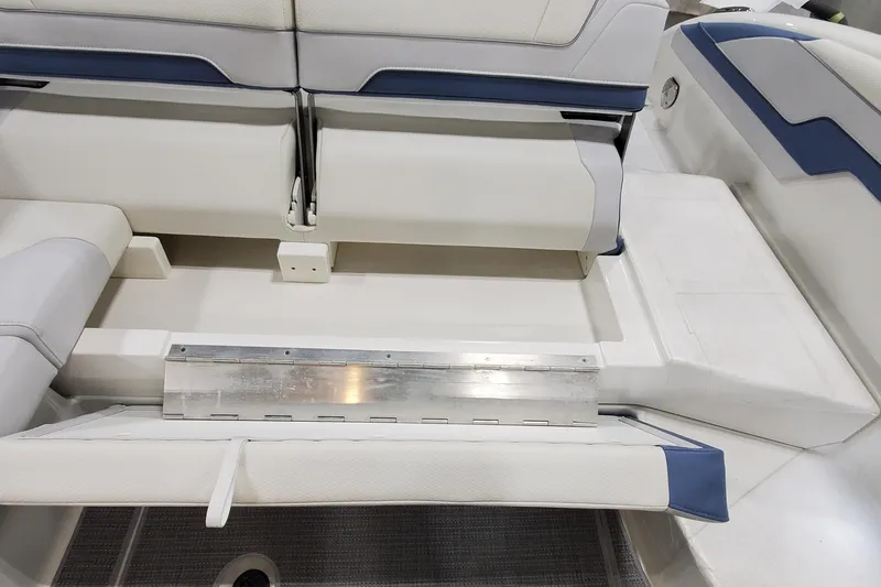 Slide: The Image of 2020 Formula 310 Bowrider interior seating with white and blue upholstery. - 13