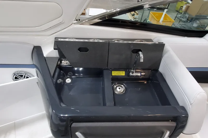 Slide: The Image of 2020 Formula 310 Bowrider boat sink with faucet and storage compartments. - 16