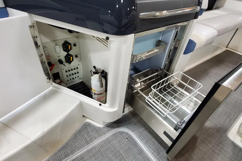 Slide: The Image of 2020 Formula 310 Bowrider interior showing control panel and open storage compartment. - 17