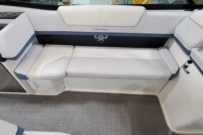 Slide: The Image of 2020 Formula 310 Bowrider interior seating with white and blue upholstery. - 21