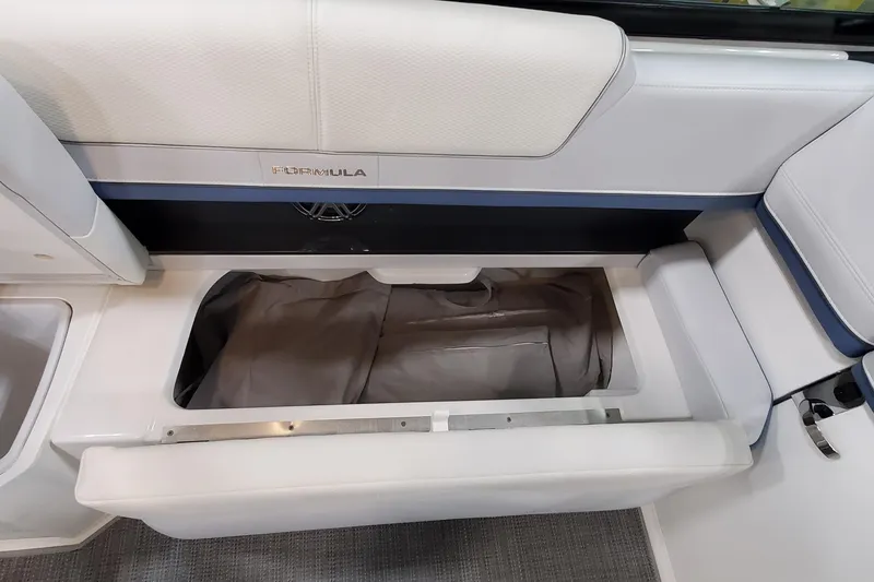 Slide: The Image of 2020 Formula 310 Bowrider interior storage compartment with open seat cushion. - 22