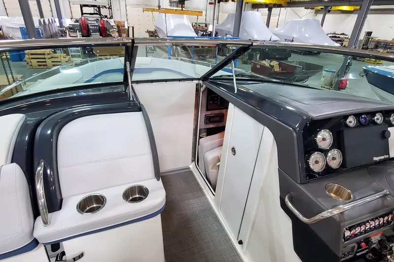 Slide: The Image of 2020 Formula 310 Bowrider interior with dashboard, gauges, and seating in a showroom. - 25