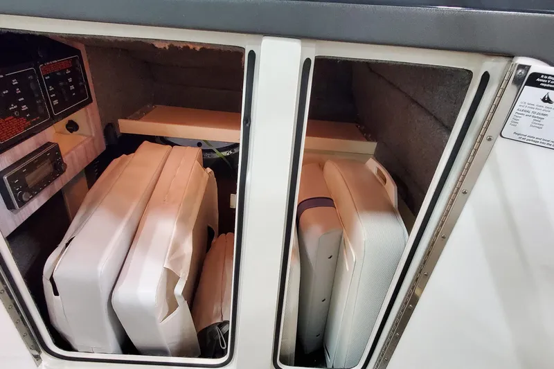 Slide: The Image of Storage compartment in a 2020 Formula 310 Bowrider boat with cushions and control panel. - 27