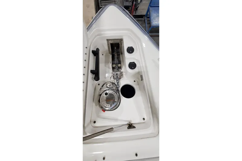Slide: The Image of 2020 Formula 310 Bowrider anchor compartment with winch and controls. - 31