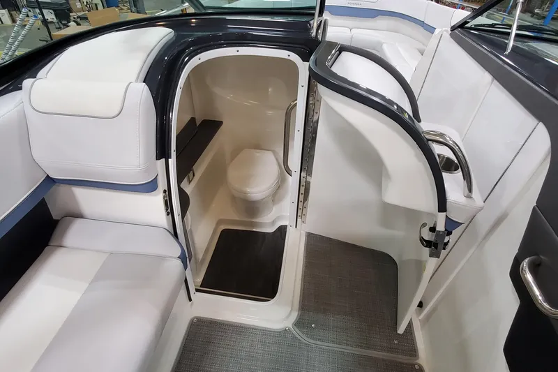Slide: The Image of 2020 Formula 310 Bowrider interior with compact marine toilet and seating area. - 33
